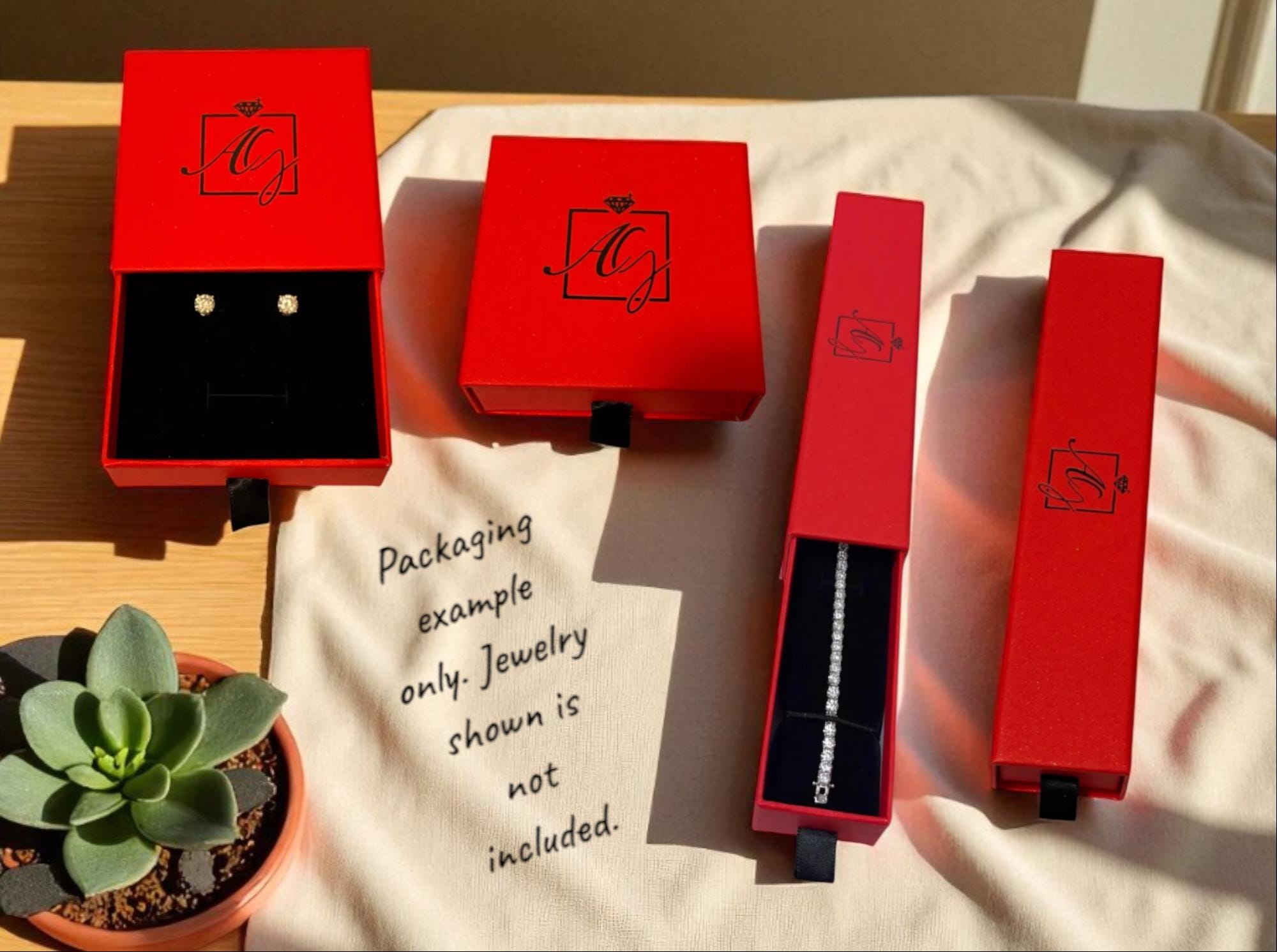Aqua Gold Jewelry red gift boxes, shown as a packaging example; jewellery not included